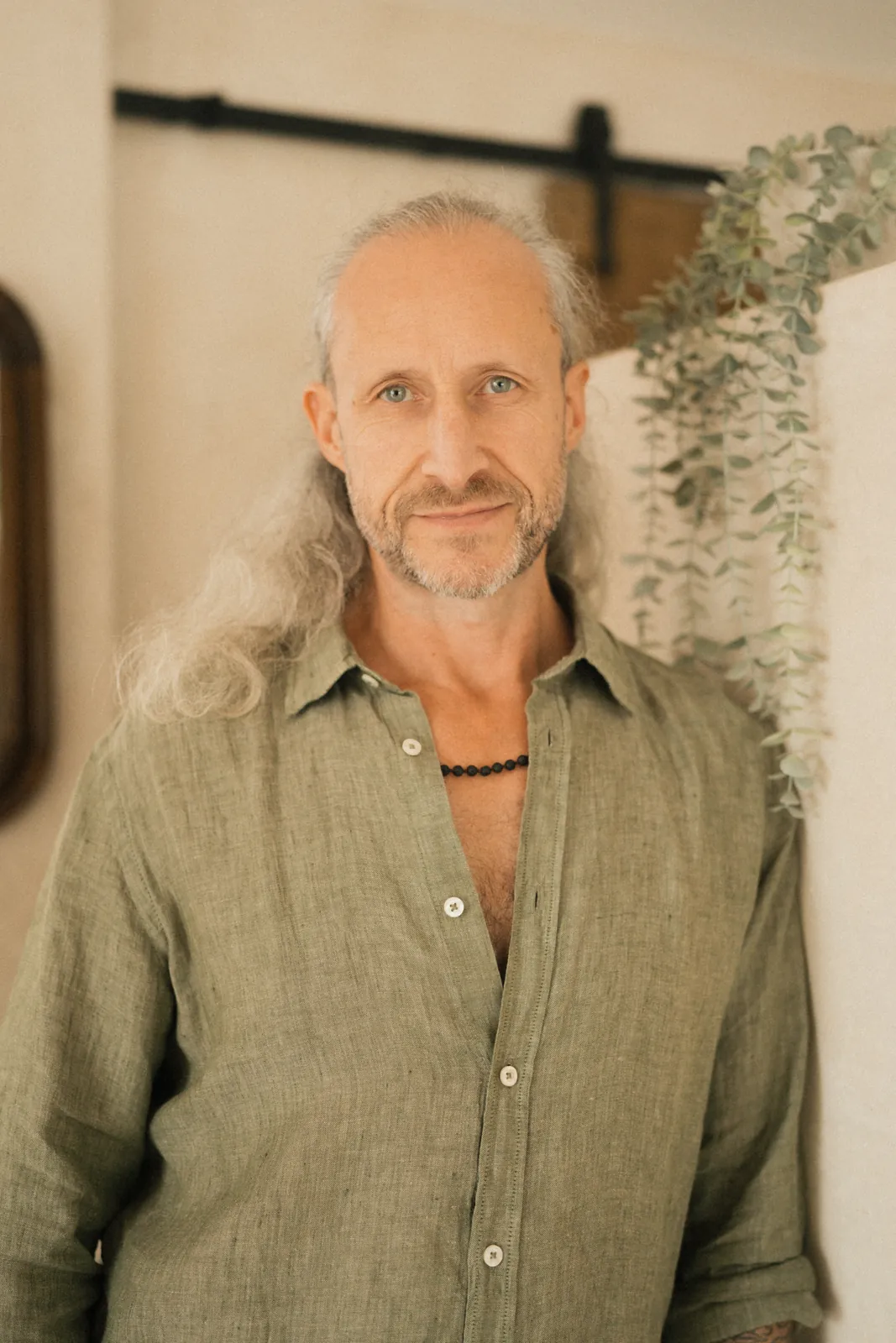 Steve Shiva standing in a green linen shirt