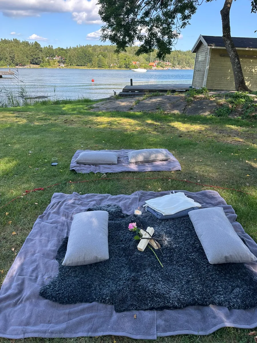 Blankets and cushions laid out by the water