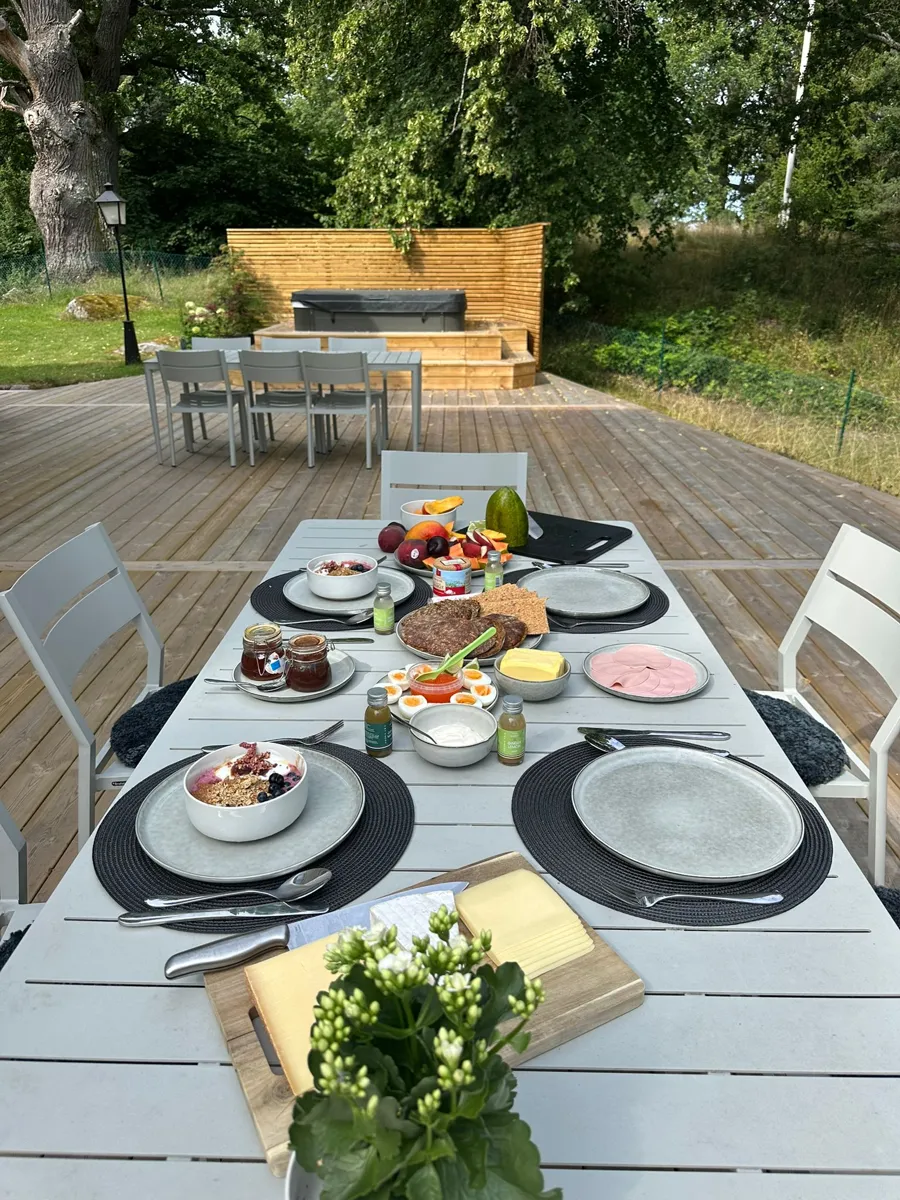 Breakfast table set on a lakeside deck