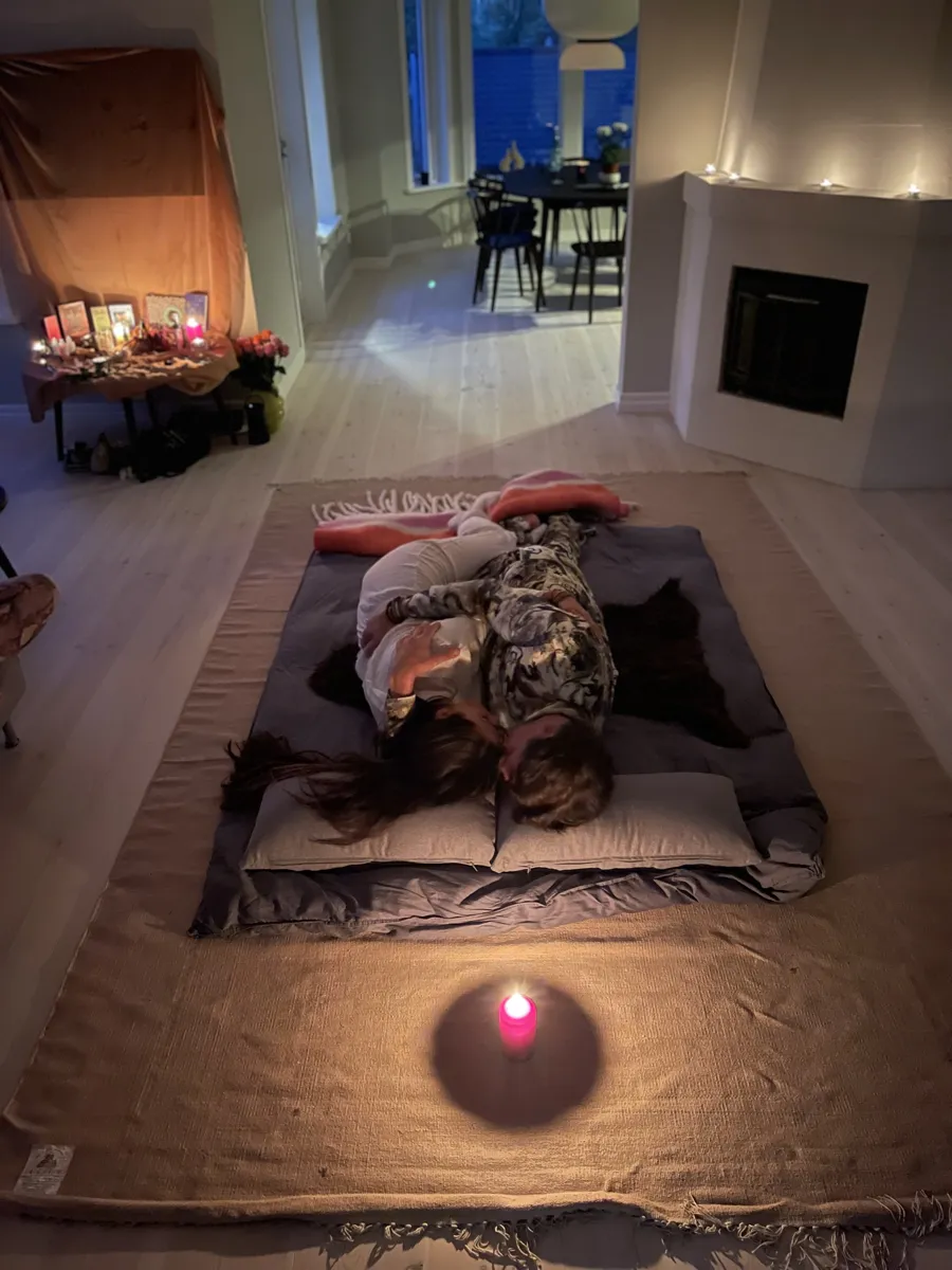 A candlelit temple space prepared for an evening ritual