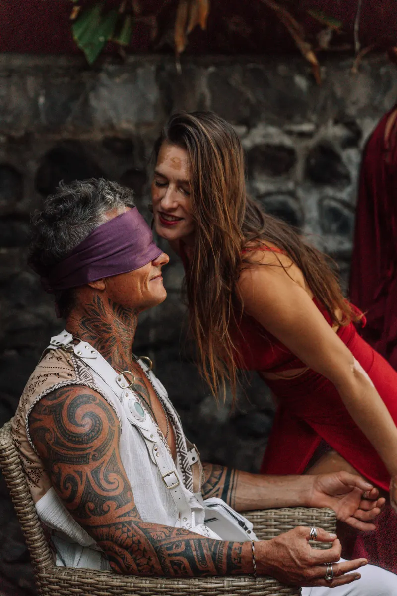 A blindfolded man met by the women