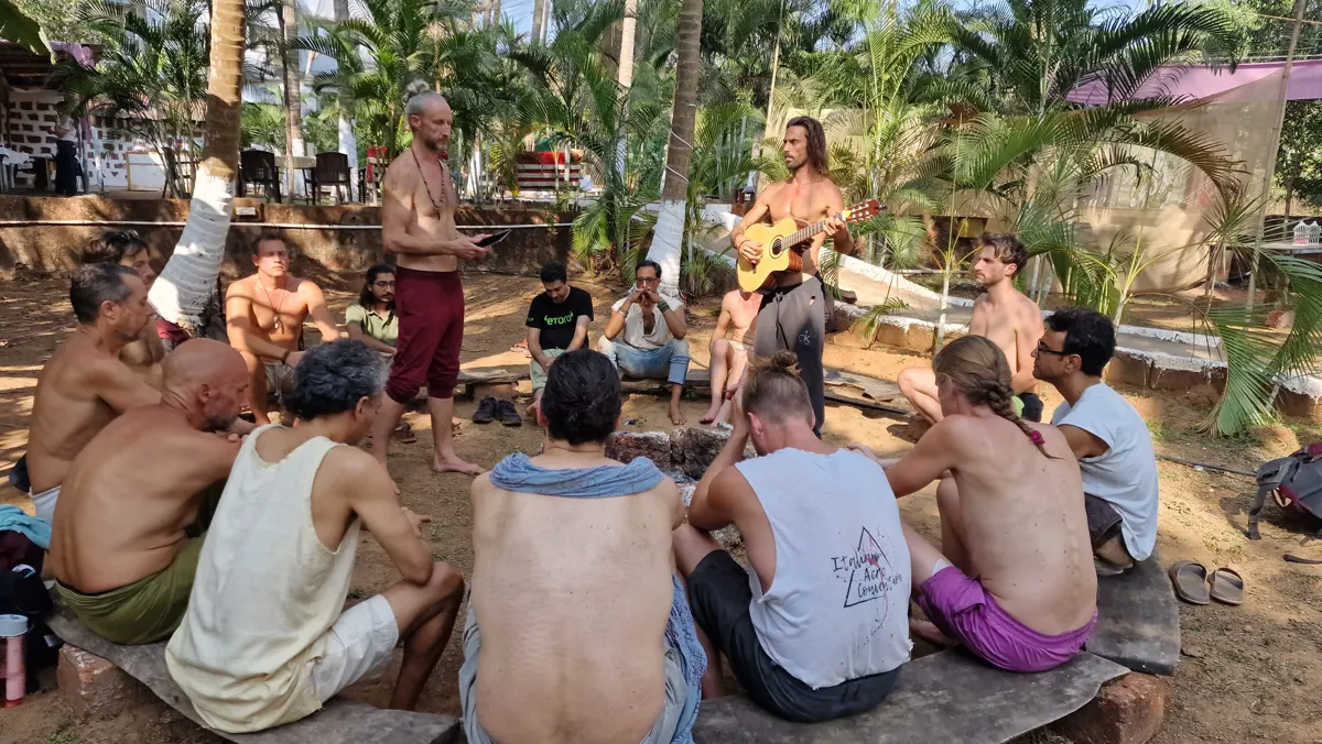 The men in circle under the palms