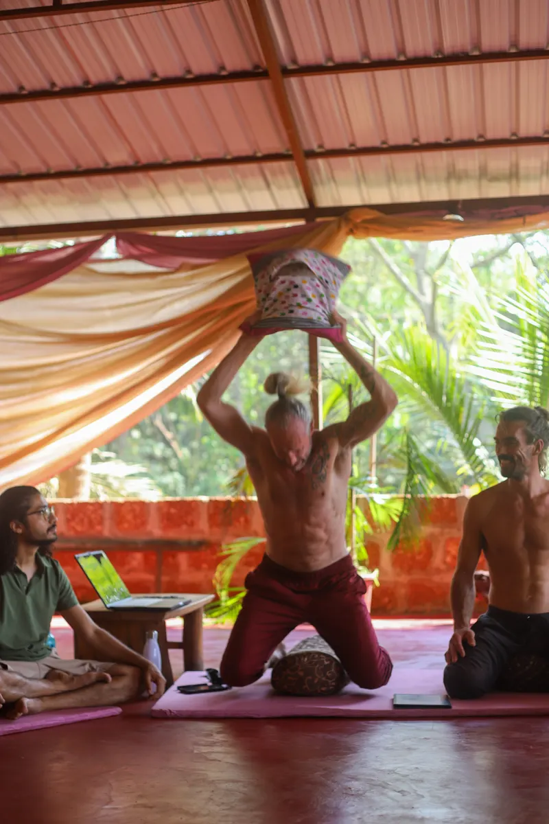 A man with arms raised in practice