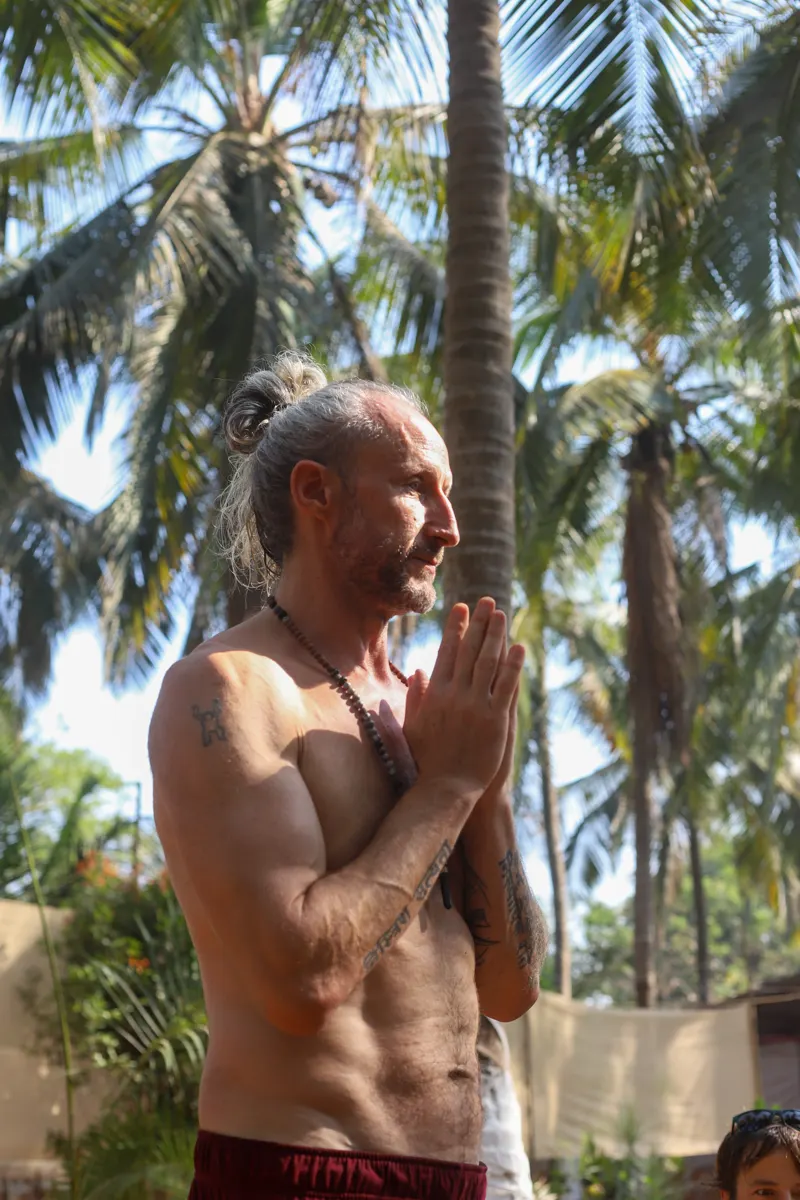 Steve Shiva in prayer under the palms