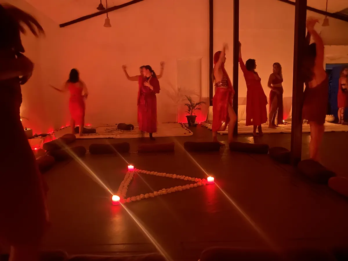 The women in the red-lit temple