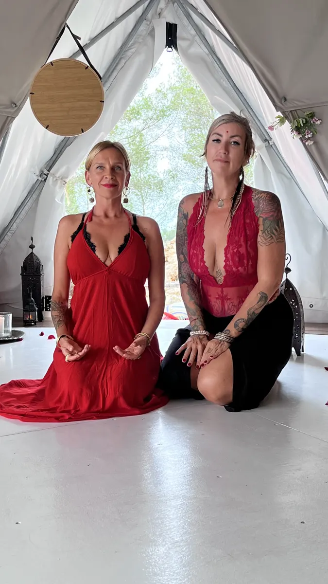 Two women of the Initiatress in red in the dome