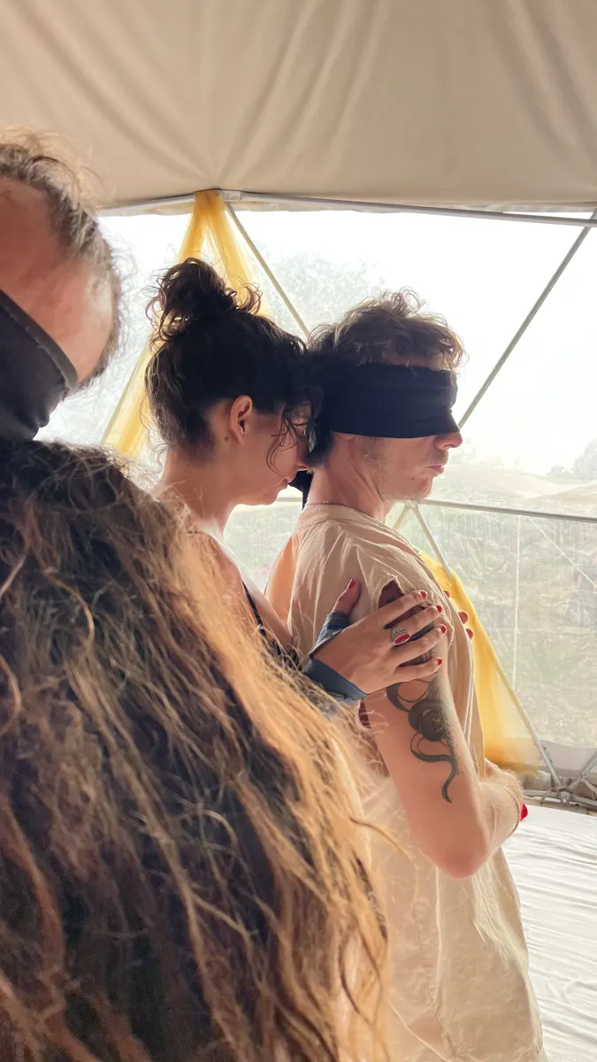 A blindfolded man meeting the women