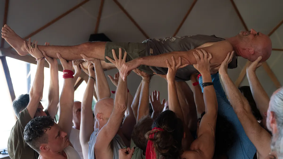 The men lifting a brother overhead
