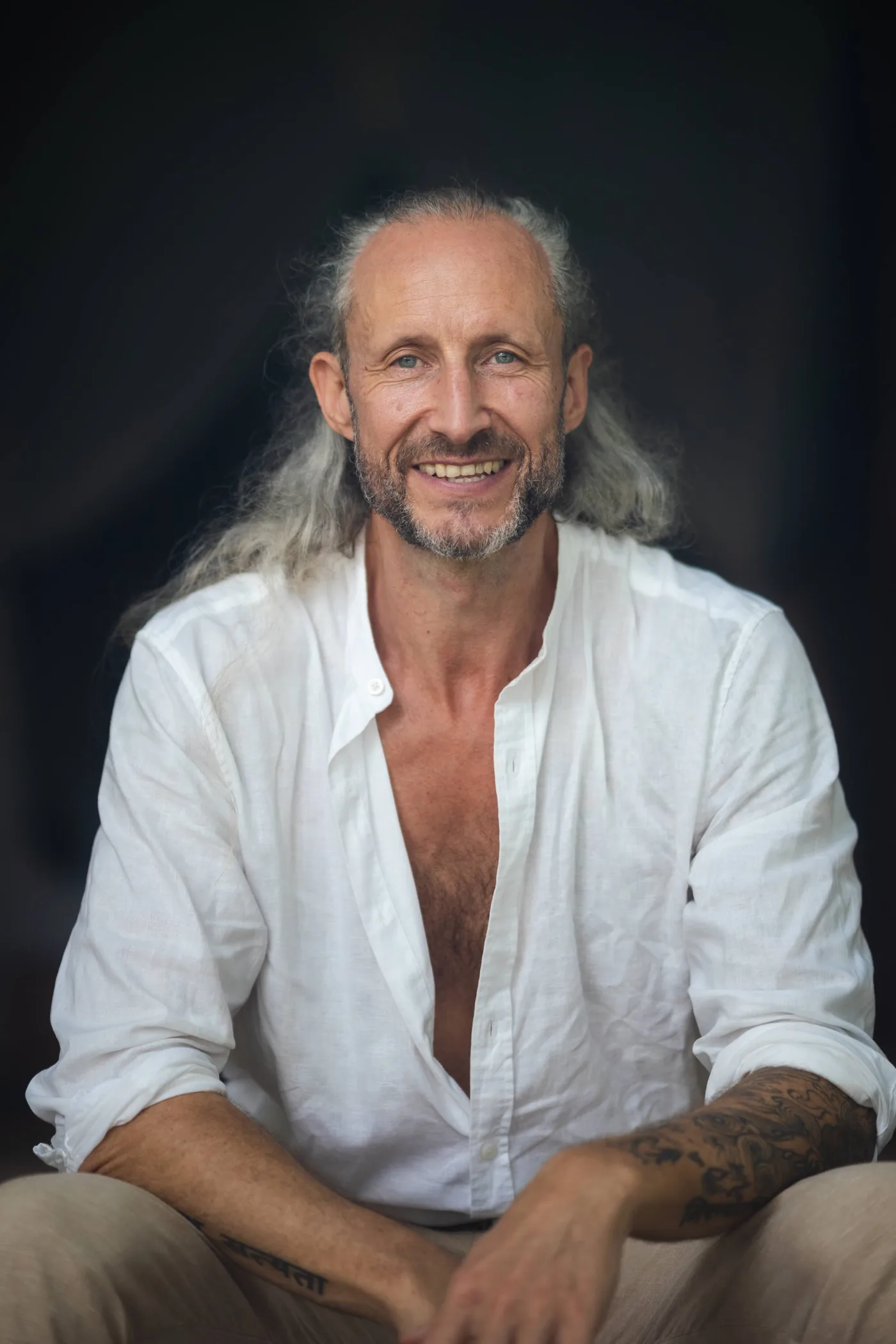Steve Shiva in a white shirt, smiling