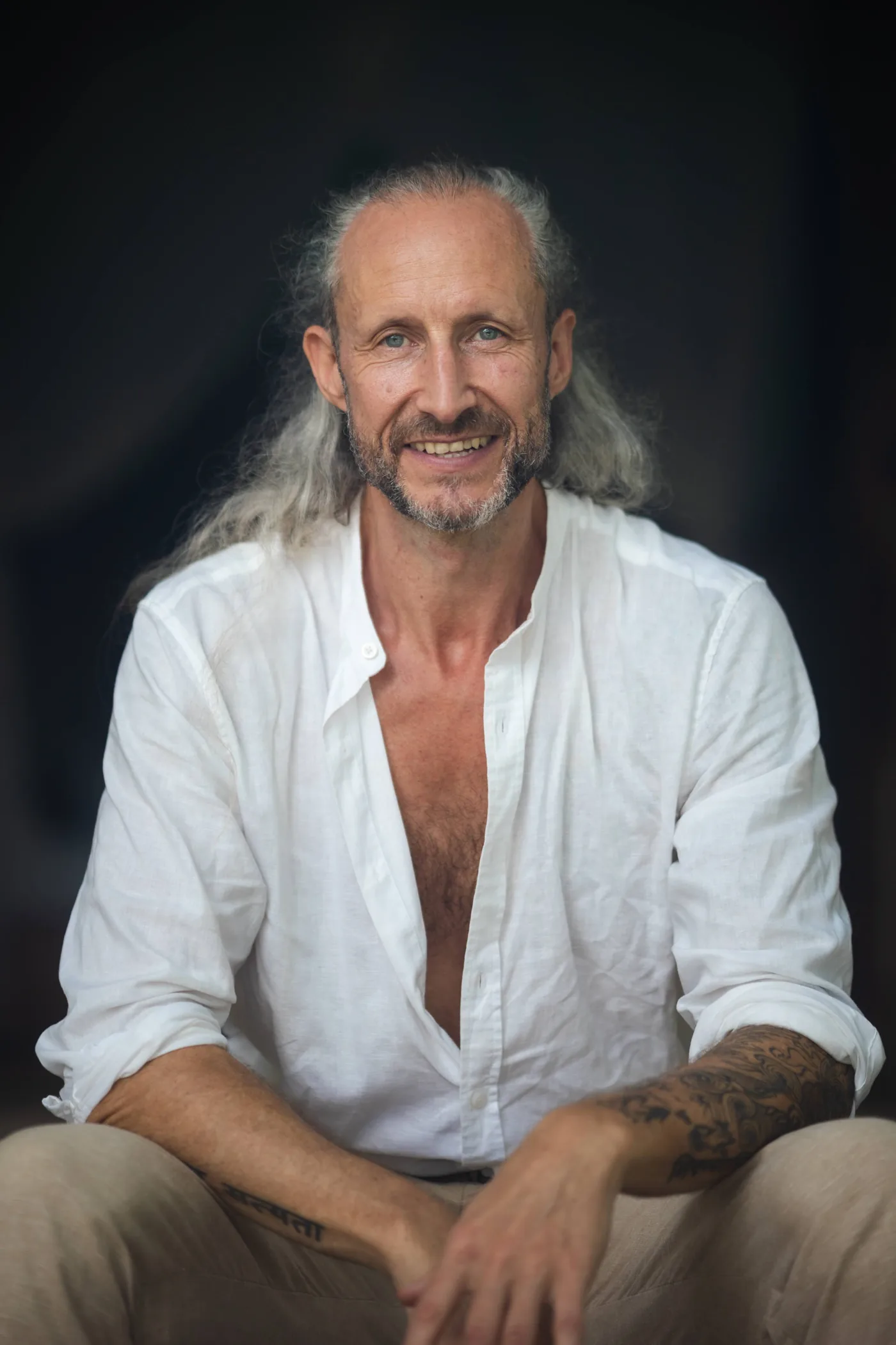 Steve Shiva smiling in a white shirt